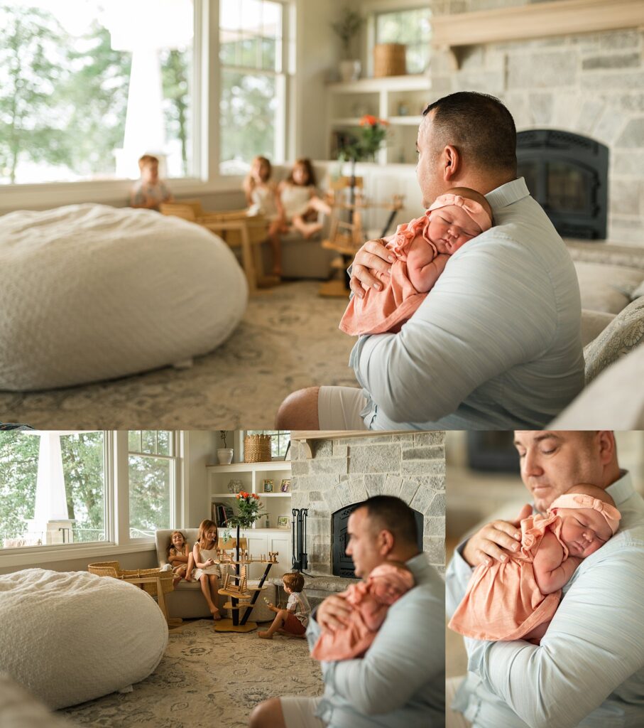 dad holds newborn baby girl while gazing at his three older children