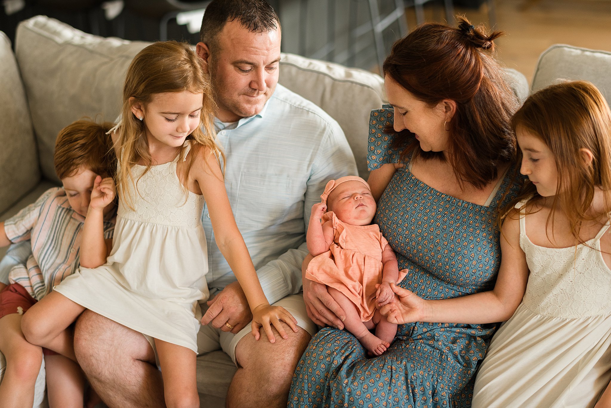 Family of 6 gathered around newborn baby in Pasadena Maryland