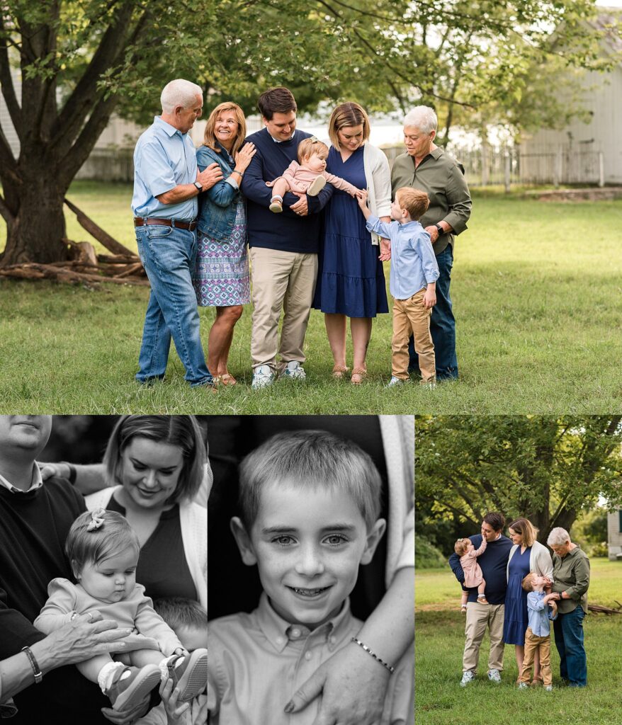 family of mom, dad, son and baby girl stand with grandparents in a field, in the shade of a tree